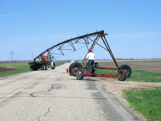 Towing a pivot section to a new location.